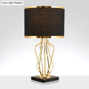 Elegant gold-toned decorbites™ simplicity drum nightstand lamp with black fabric shade and black marble base for led use