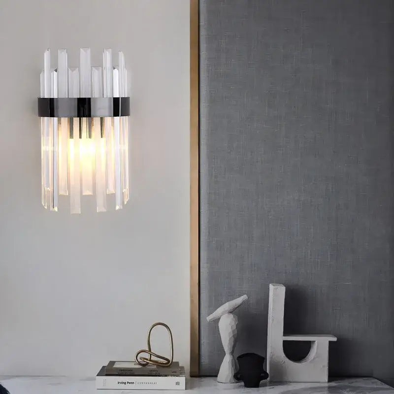 Elegant gold and crystal led wall lamps featuring vertical crystal rods and sleek black metal band for living space decor