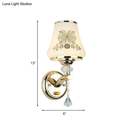 Elegant gold finished wall light with cream ornate glass shade and crystals ideal as a single reading wall light
