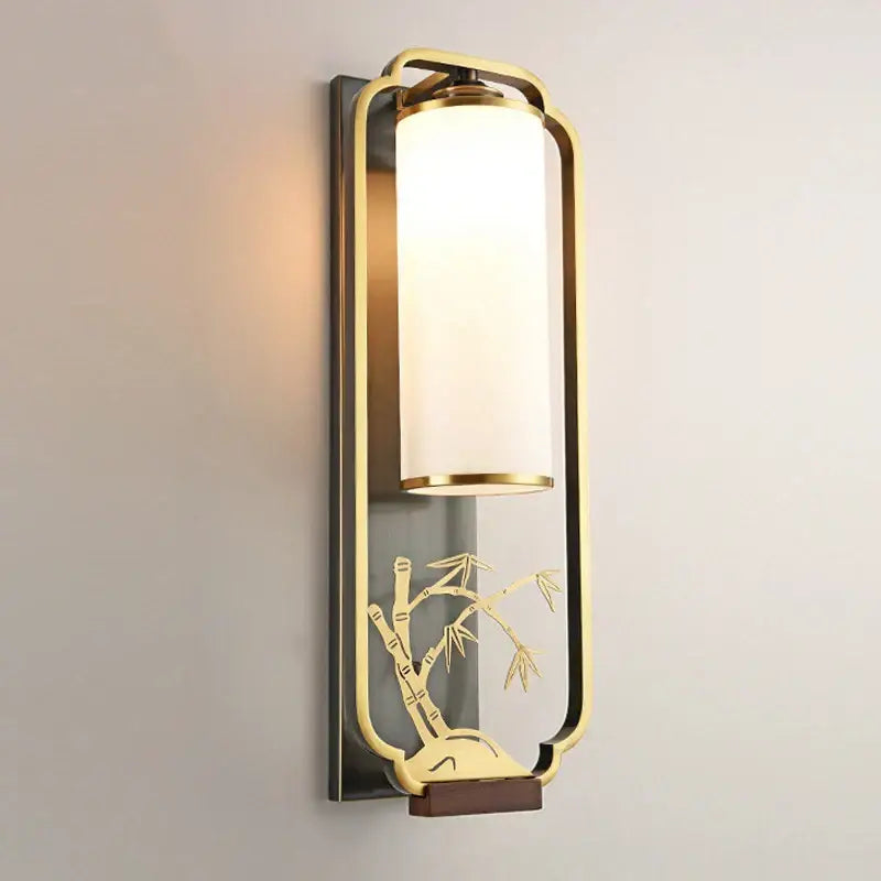 Elegant gold bamboo iron glass wall sconce with cylindrical frosted shade and ornate iron glass wall motif for living room