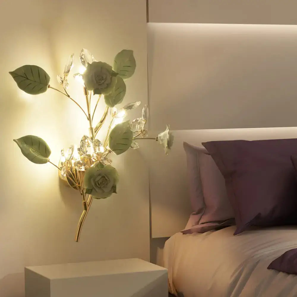Elegant gold branch wall lamp with sculpted green leaves and clear crystals direct wired electric for bedroom sconce lighting