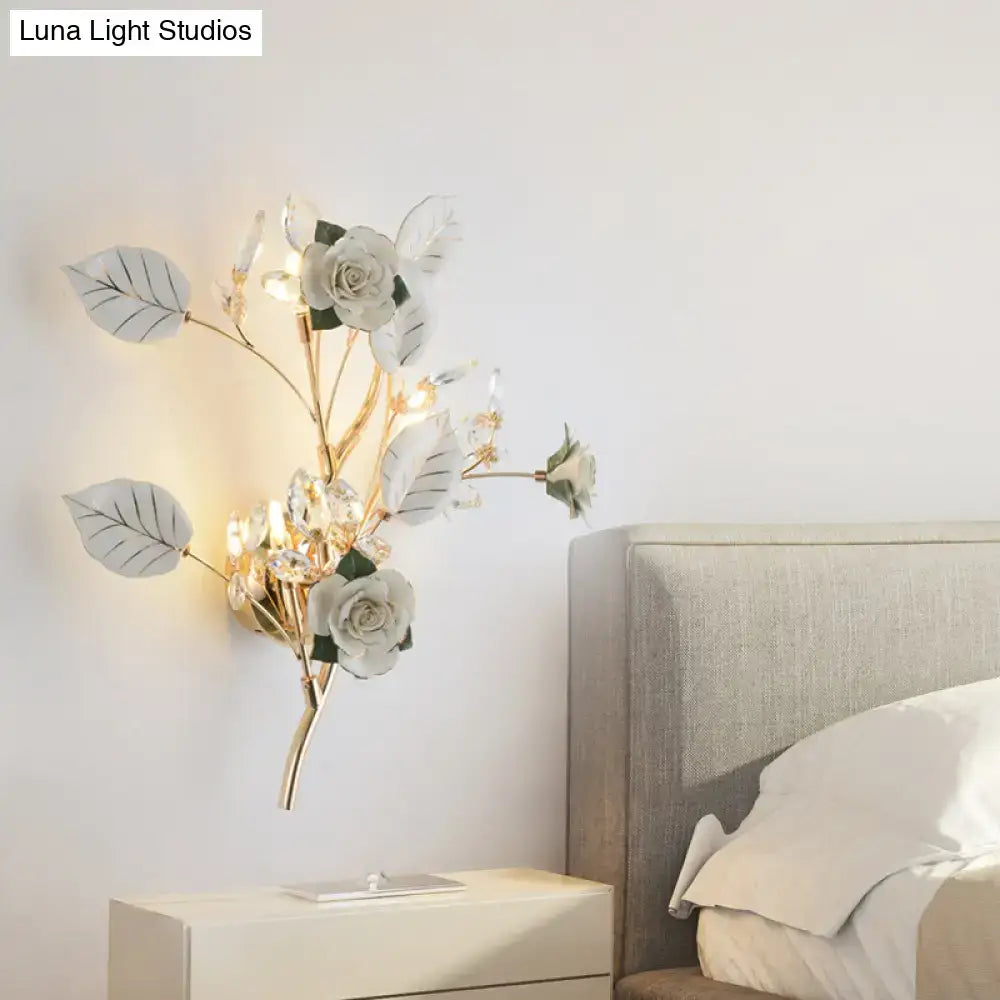 Elegant gold branch wall lamp with direct wired electric, featuring white rose and crystal accents for bedroom sconce lighting