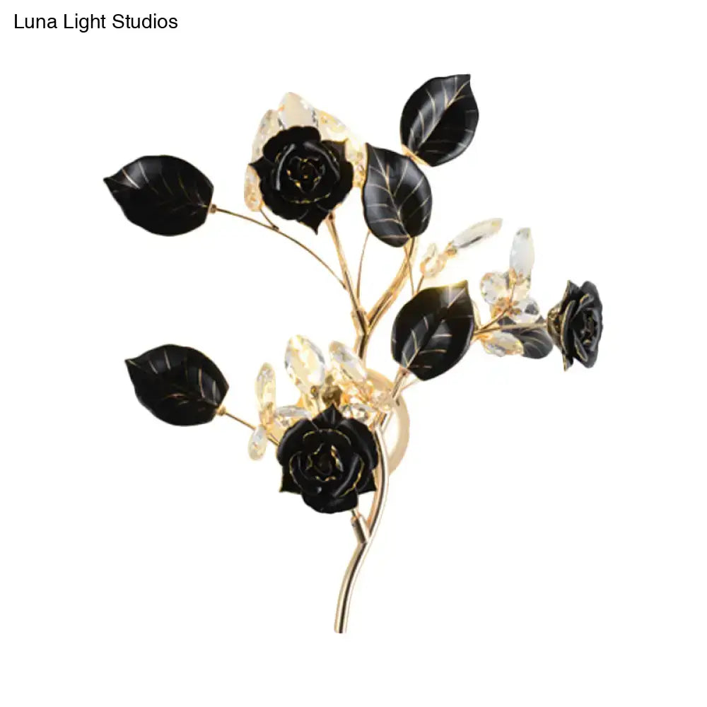 Elegant black rose and leaf branch wall lamp with gold-toned branches and crystals for direct wired electric lighting