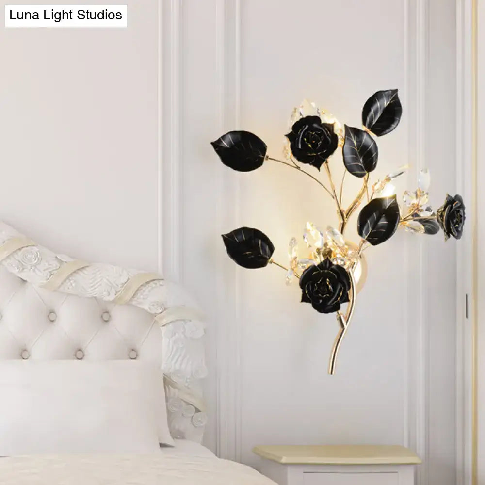 Elegant black rose and leaf branch wall lamp with gold-toned stems and crystal accents for direct wired electric use