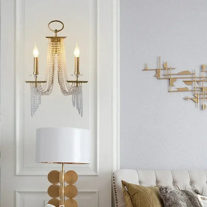 Elegant gold decorbites crystal candle chandelier with two candle-style bulbs and cascading crystal strands for dining room decor