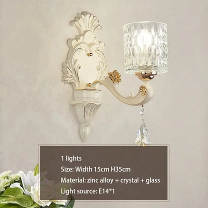 Elegant off-white ornate wall sconce with faceted crystal glass shade and gold accents for decorbites elegant crystal chandelier decor