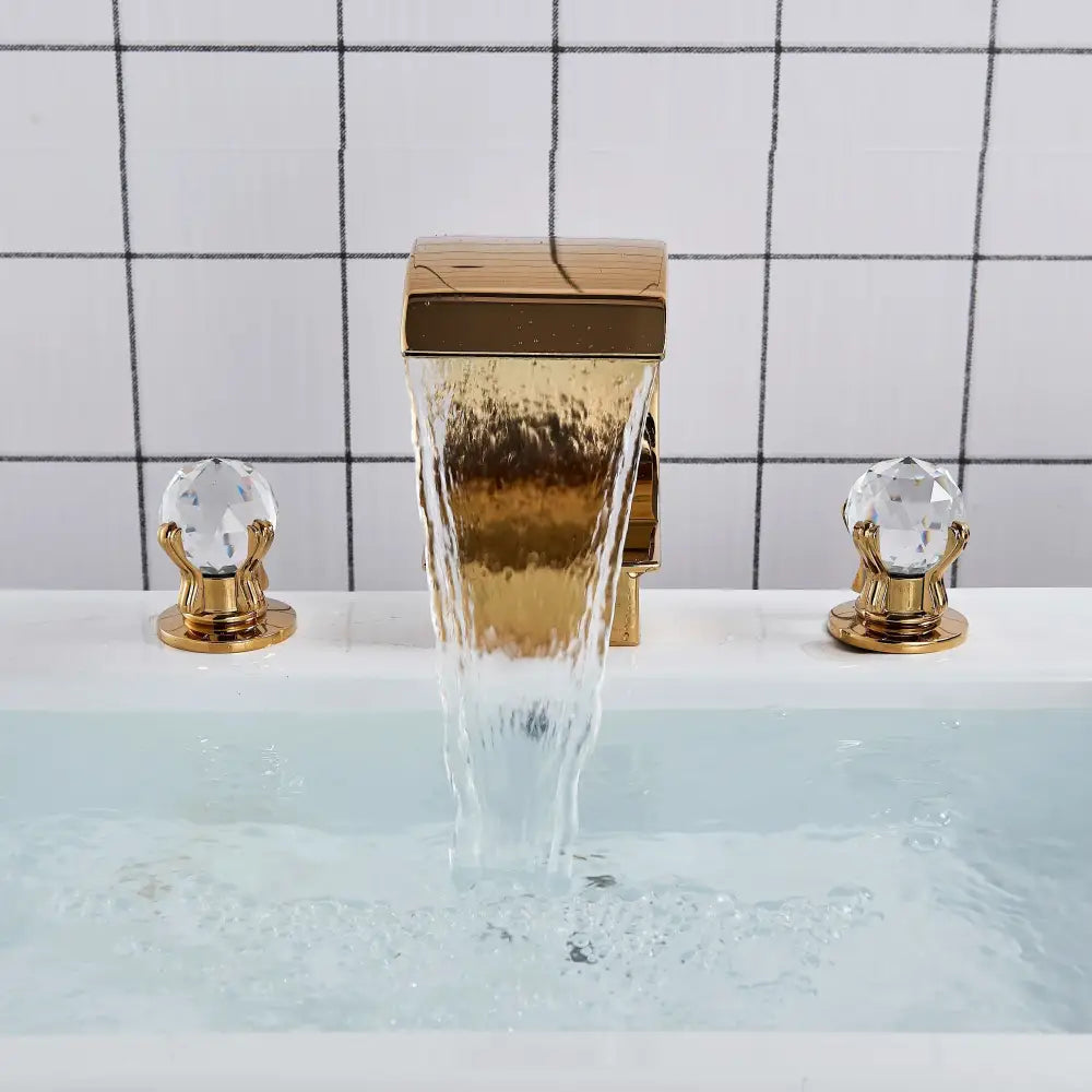 Elegant gold crystal handle waterfall basin faucet set featuring gold finish and crystal knobs for bathroom use