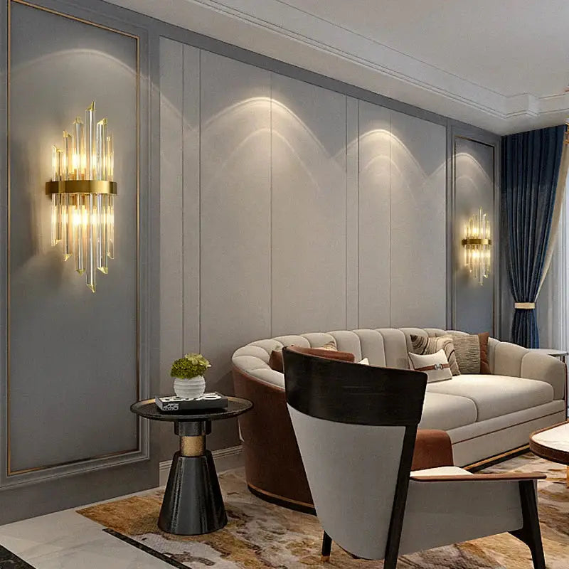 Gold-toned crystal led wall lamp with vertical glass rods and circular brass base for elegant bedroom decorbites wall lamps