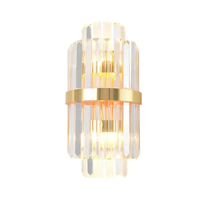 Elegant gold wall sconce light with stacked crystal prisms and central brass band for living room lighting
