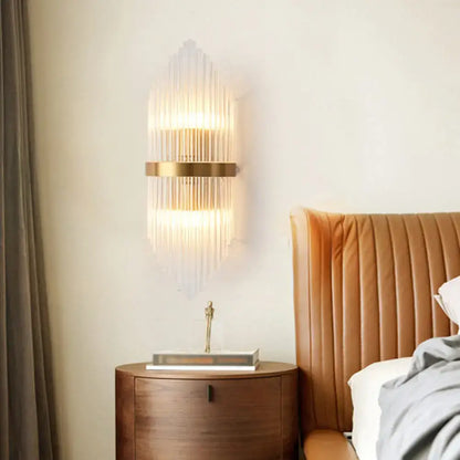 Elegant gold crystal prism wall sconce light with vertical glass prisms and metal frame for living room lighting