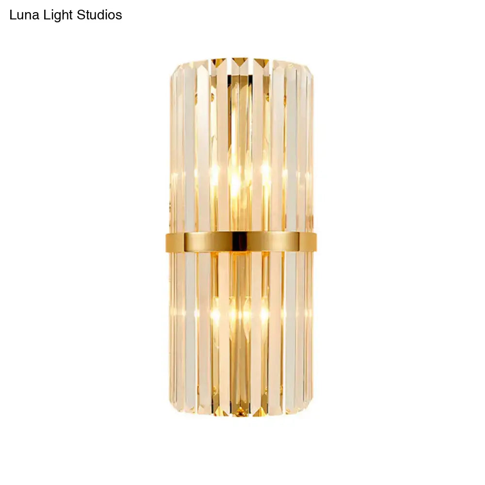 Elegant gold crystal prism wall sconce light with vertical rods and a gold-toned band for living room lighting