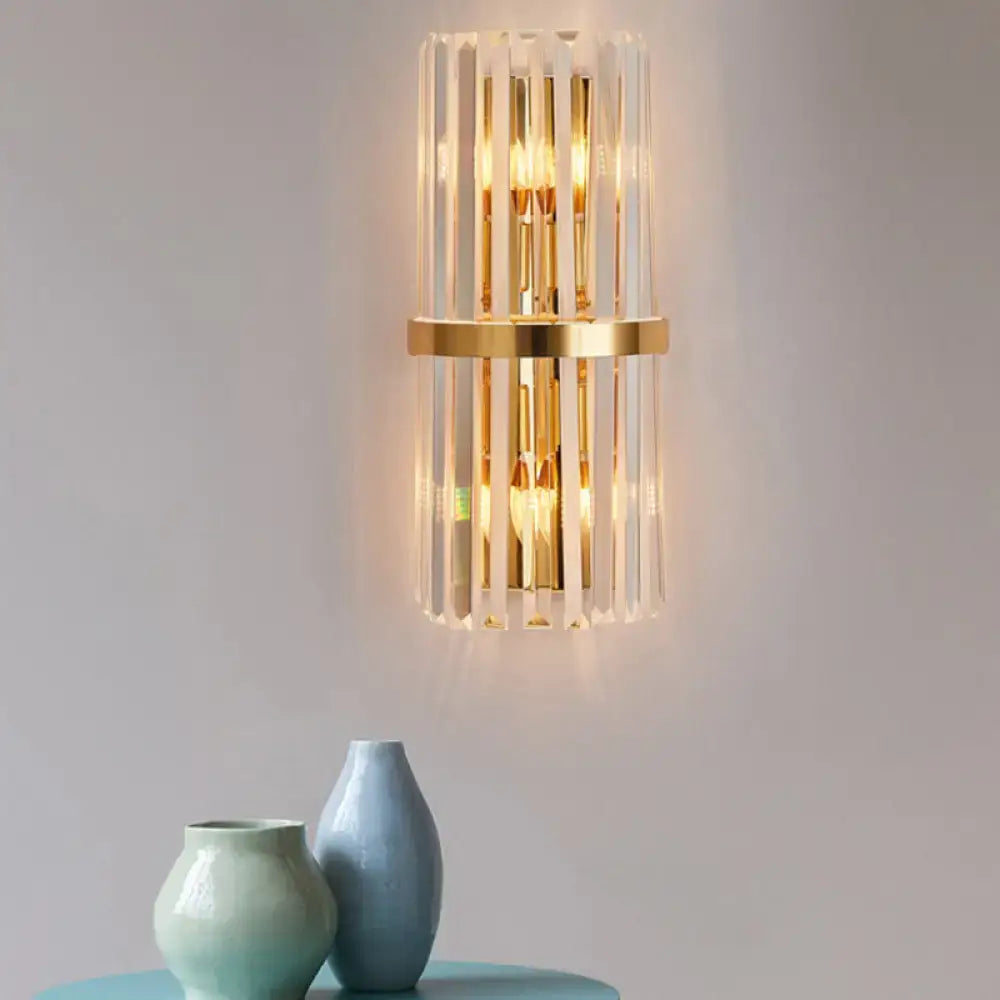 Elegant gold wall sconce light with vertical crystal rods and central circular accent for living room lighting
