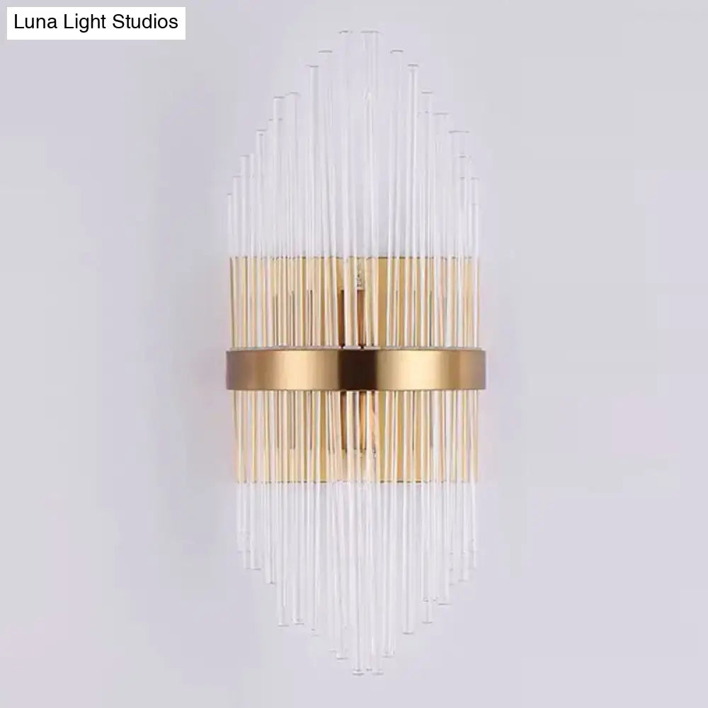 Elegant gold-toned wall sconce light with clear crystal prism rods radiating from a central horizontal band for living room lighting