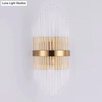 Elegant gold-toned wall sconce light with clear crystal prism rods radiating from a central horizontal band for living room lighting