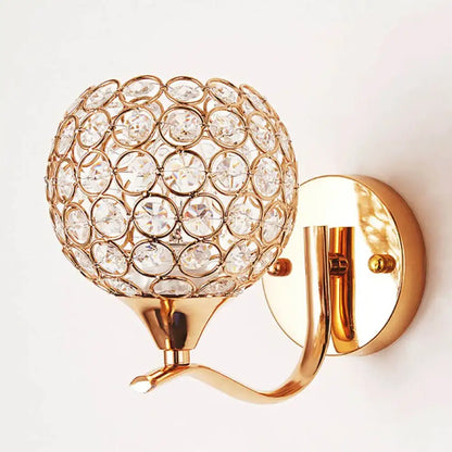 Elegant gold crystal wall sconce featuring a spherical globe design for bedroom lighting by decorbites crystal wall