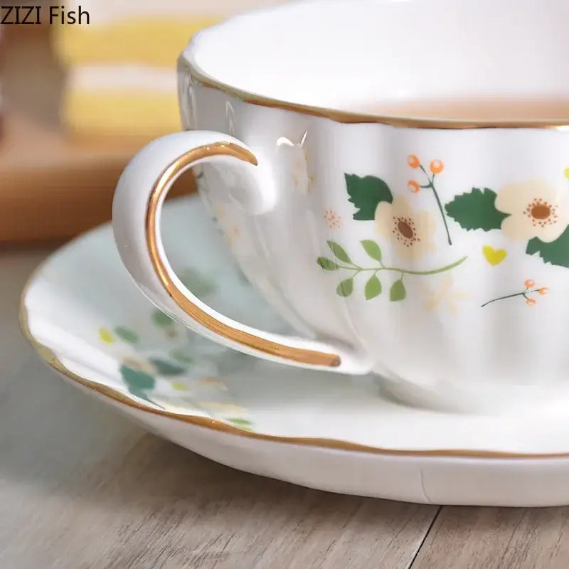 Elegant gold flower porcelain cup and saucer set with soft floral patterns and gold trim by decorbites elegant gold