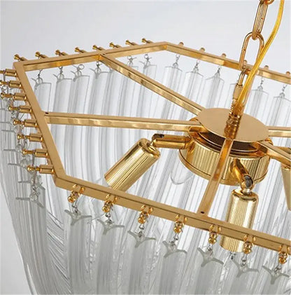 Elegant gold glass tube pendant chandelier with geometric frame, clear crystal strands, and star-shaped accents for dining rooms