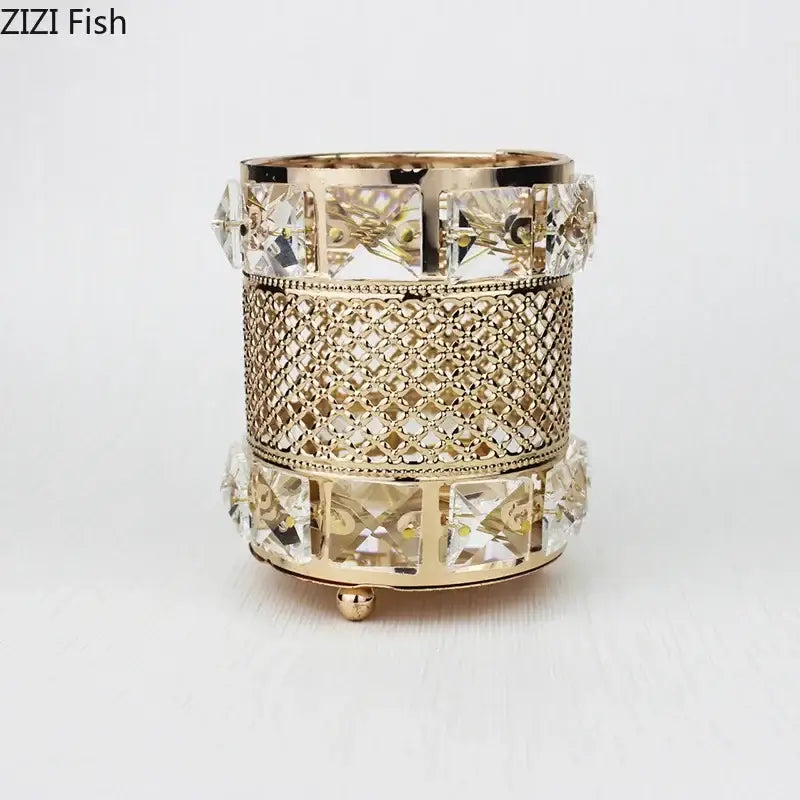Elegant gold-toned hollow glass jar candle holder with crystal accents and intricate mesh detailing for decorative use
