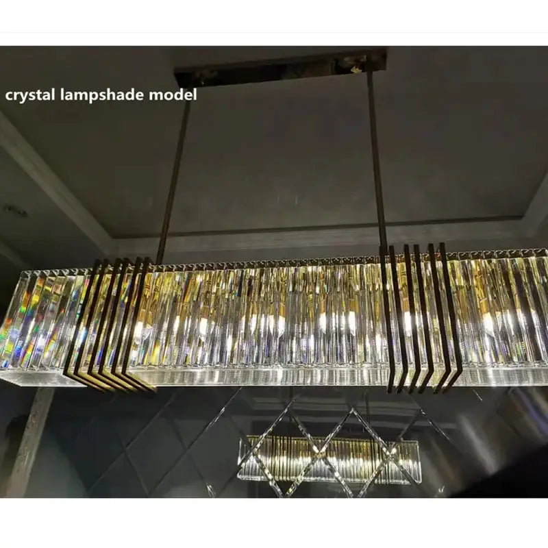 Elegant gold lustre pendant light with long rectangular crystal lampshade and gold-toned metal accents by decorbites elegant gold