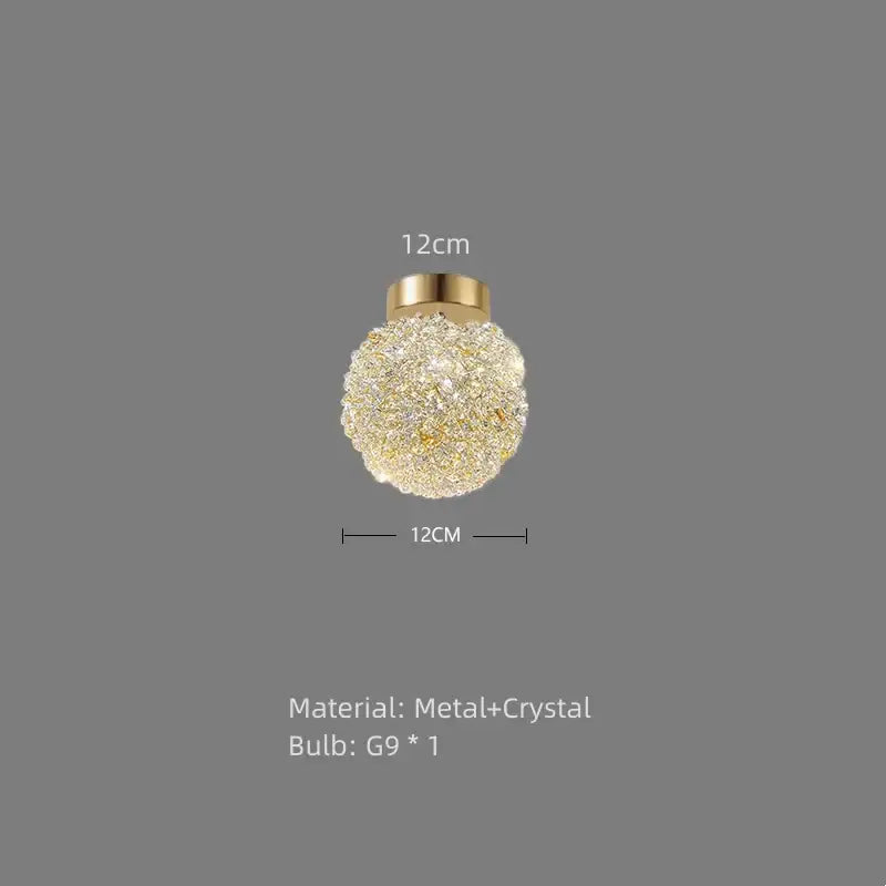 Spherical pendant light with decorbites gold metal base and intricate gold metal crystal design for dining room decor