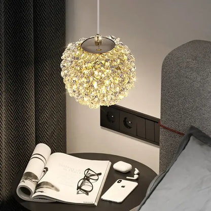 A sparkling gold metal crystal pendant light with spherical clustered design hanging for dining room decorbites gold metal