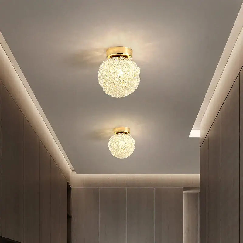 Two elegant gold metal crystal pendant lights with spherical clear faceted crystals for dining room decorbites gold metal