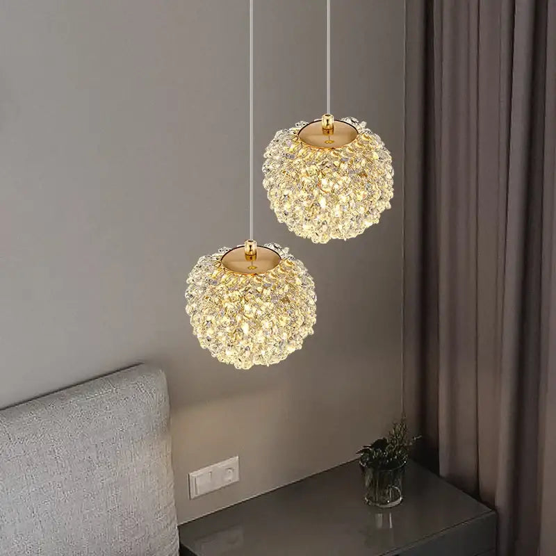 Two elegant gold metal crystal pendant lights with spherical clear faceted crystals for dining room decorbites gold metal