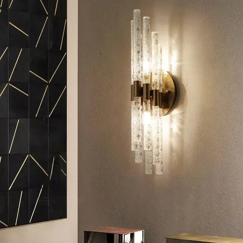 Elegant gold metal wall sconce with clear textured glass rods and brass accents for decorbites gold metal bedroom lamp