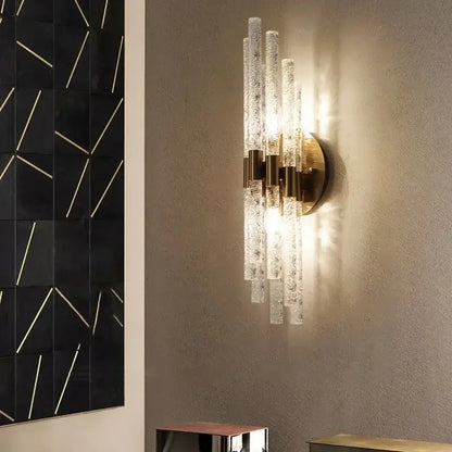 Elegant gold metal wall sconce with clear textured glass rods and brass accents for decorbites gold metal bedroom lamp