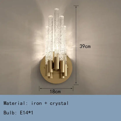 Elegant gold metal wall sconce with five textured crystal rods on a circular brass base by decorbites gold metal