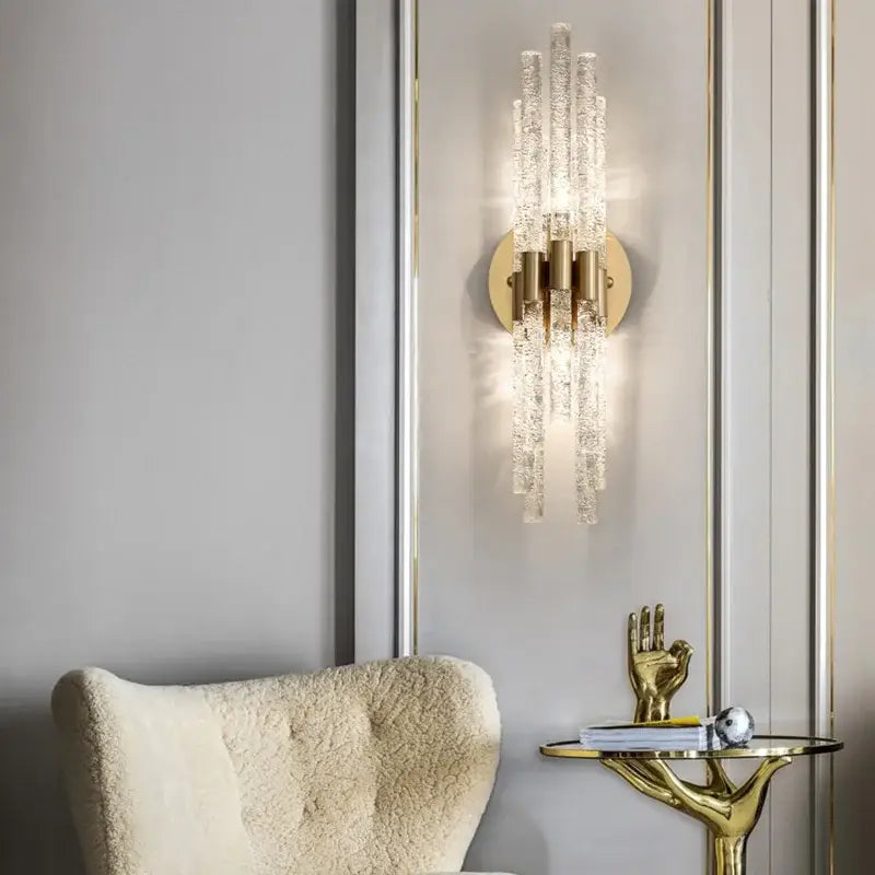 Elegant gold metal wall sconce featuring textured clear glass rods radiating downward for bedroom decorbites gold metal lighting