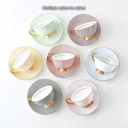 Elegant gold porcelain tea set with ribbed pastel teacups and saucers featuring gold-trimmed handles on dining rack