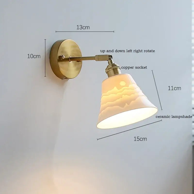 Elegant gold ruffled ceramic led wall light with warm-toned ceramic lampshade and subtle mountain design on brass arm decorbites ceramic led