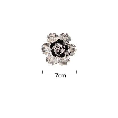 Elegant gold and silver enamel flower brooch with detailed petals complementing decorbites elegant porcelain wall ornaments