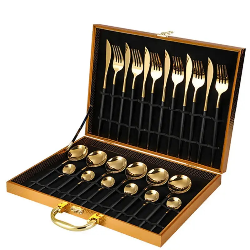 Elegant gold stainless steel cutlery set with black handles neatly arranged in a wooden carrying case gift box
