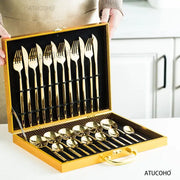 Elegant gold stainless steel cutlery set in a matching gold-trimmed presentation case with black velvet lining