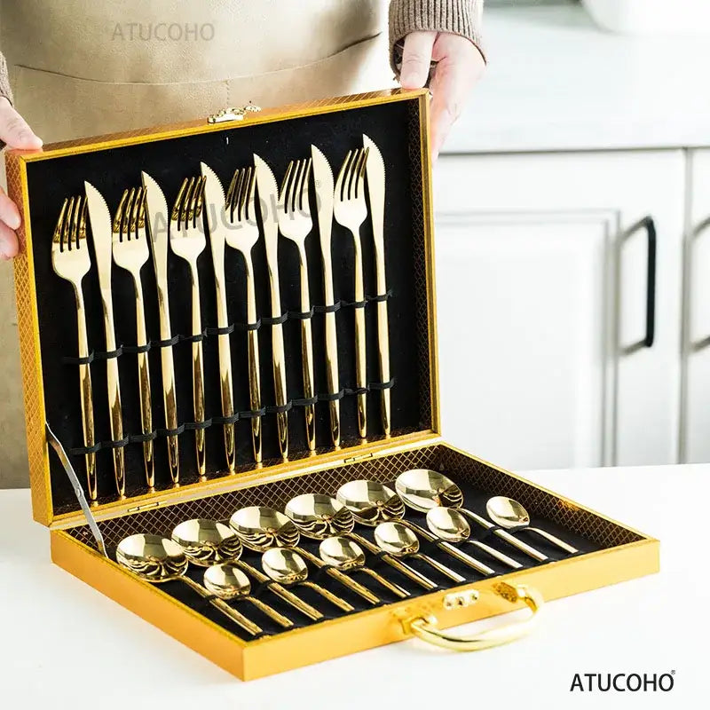 Elegant gold stainless steel cutlery set in a matching gold-trimmed presentation case with black velvet lining