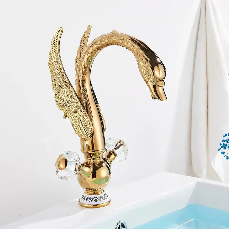 Elegant gold swan basin faucet with intricate feather detailing and crystal knobs by decorbites for bathroom use