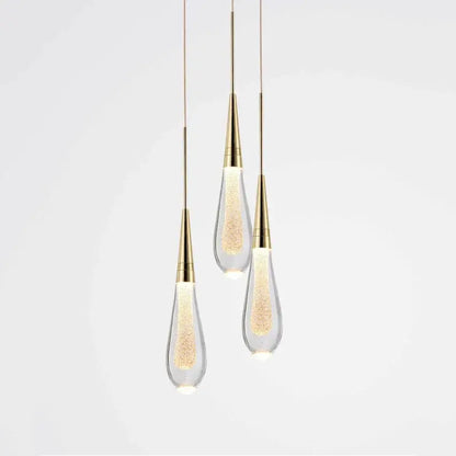 Elegant gold pendant lights with teardrop decorbites crystal glass led shades filled with glowing golden particles for dining room