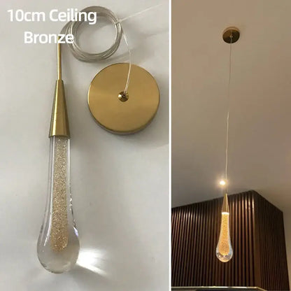 Elegant gold teardrop crystal glass pendant light with clear glass shade filled with golden glitter for dining room decorbites crystal glass