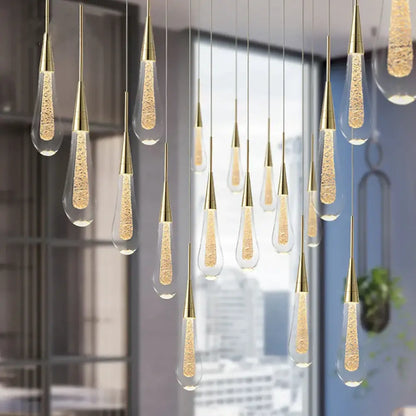 Elegant gold pendant light with clear crystal glass teardrop shades filled with glowing golden beads for dining room decorbites crystal glass