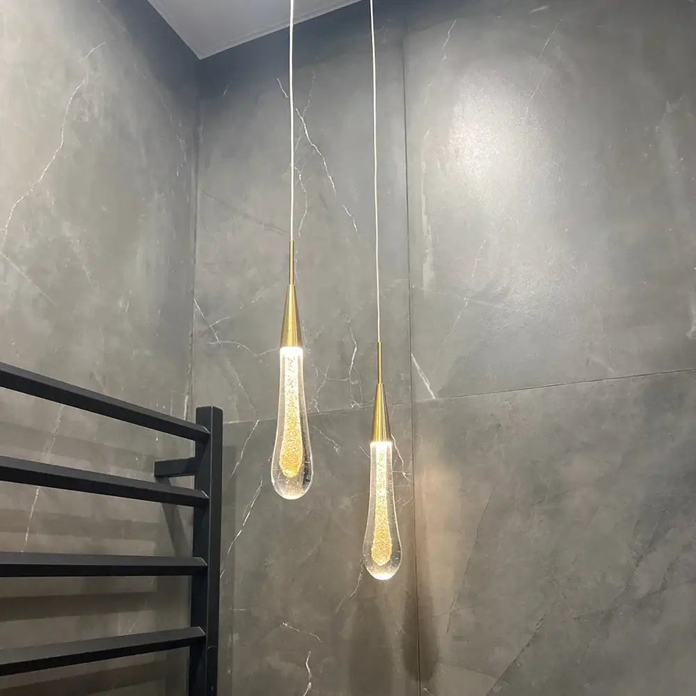 Two elegant gold-toned decorbites crystal glass pendant lights with teardrop glitter shades for dining room decor