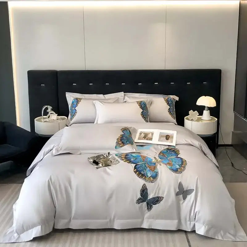 Light gray satin bedding set with elegant blue and gold decorbites butterfly embroidery on comforter and pillows