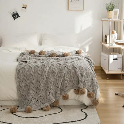 Elegant gray chenille throw blanket with textured wavy pattern and beige decorbites elegant chenille pompons edges