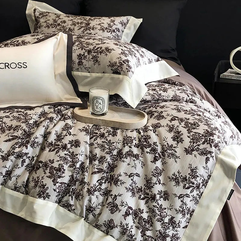 Elegant cream-colored egyptian cotton bedding set with black floral pattern and satin trim in bedroom use