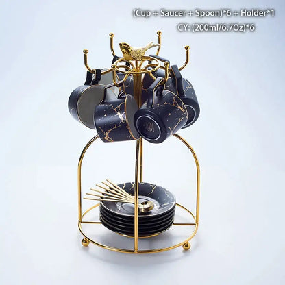 Elegant black marble ceramic tea set with gold veining includes cups, saucers, spoons on a golden metal stand