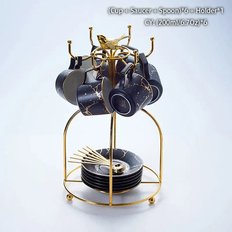 Elegant black marble ceramic tea set with gold veining includes cups, saucers, spoons on a golden metal stand