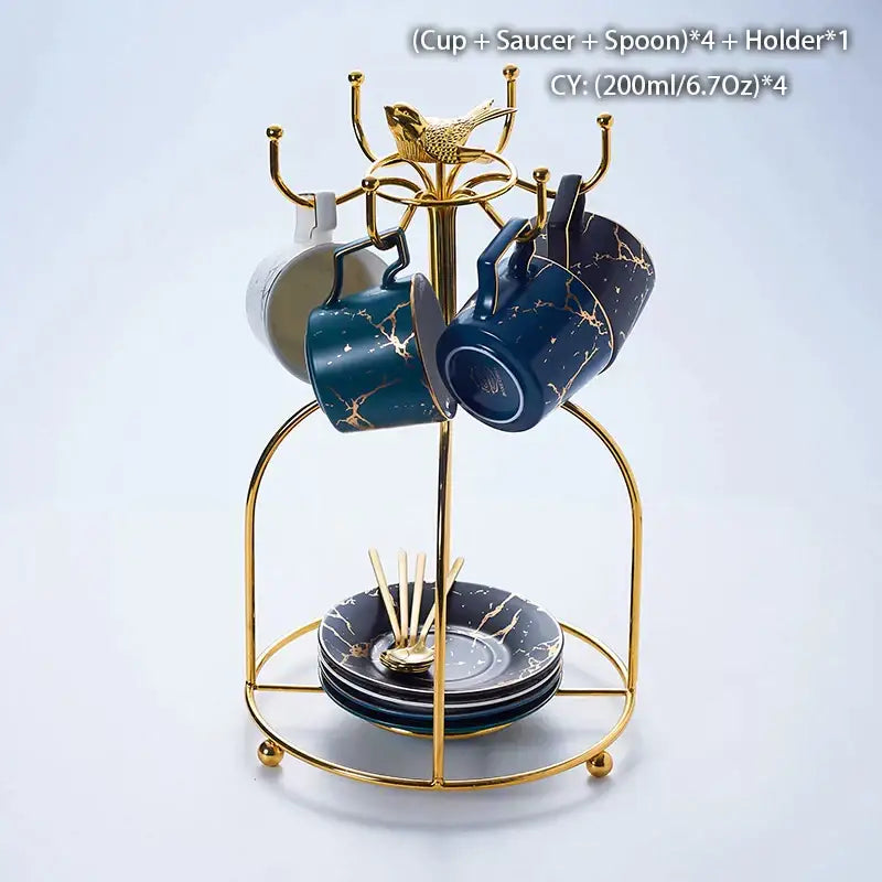 Gold-toned metal cup and saucer set with navy blue marble ceramic tea cups and matching spoons in elegant ceramic tea set