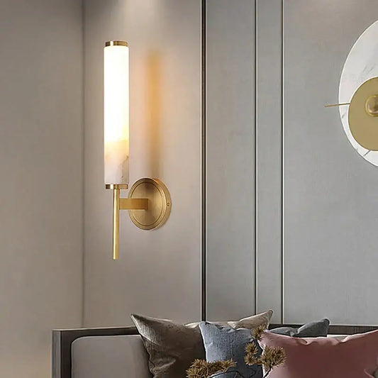 Gold-toned elegant marble copper wall sconce with cylindrical frosted glass shade for bedroom lighting decorbites elegant marble