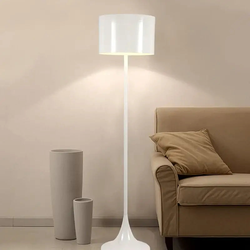 A sleek white floor lamp with a cylindrical shade and tapered base for decorbites elegant mushroom floor decor